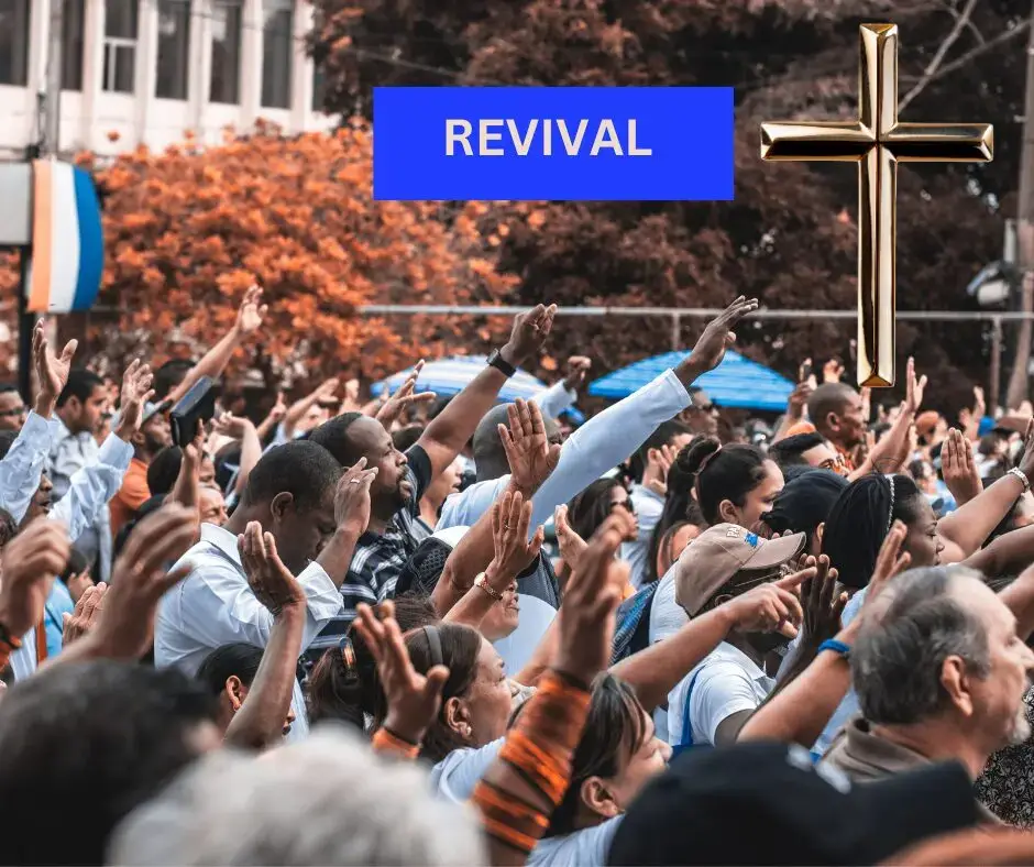 Crowd at revival event with cross symbol.